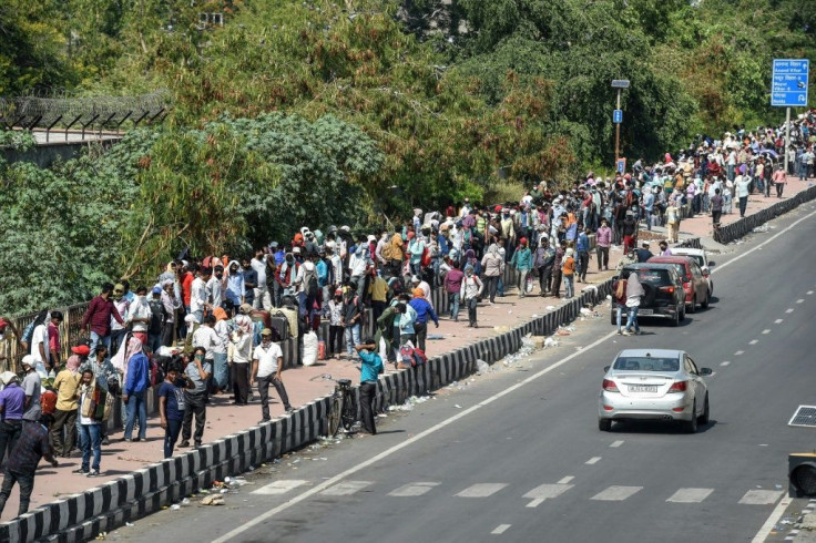 Migrant workers and their families queue to  register for inter-state trains in Ghaziabad, Uttar Pradesh, after the Indian government began easing lockdown restrictions