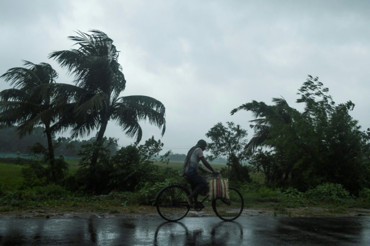 A man rides a bicycle under the rain ahead of the expected landfall of Cyclone Amphan in Midnapore, West Bengal, on May 20, 2020