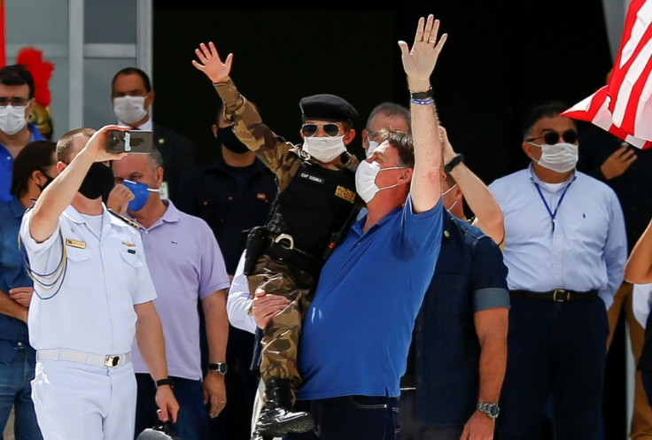 Brazil's President Jair Bolsonaro, pictured (center, in blue) on May 17 2020, shares his US counterpart's tendency to disregard scientific evidence that contradicts him