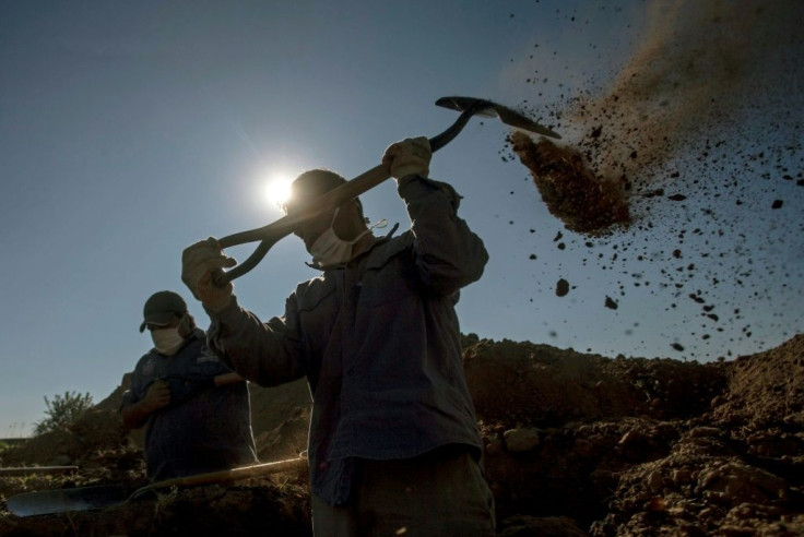 Cemetery workers dig graves at the San Vicente cemetery in Cordoba, Argentina, which has seen a spike in infections