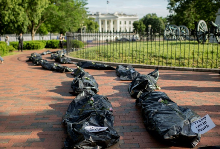 Demonstrators display fake body bags during a protest in front of the White House in Washington, DC