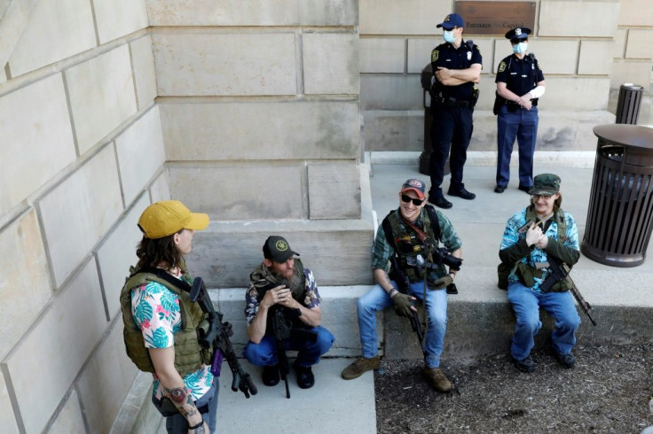 Armed protesters demonstrate outside the Michigan State Capitol in Lansing, Michigan