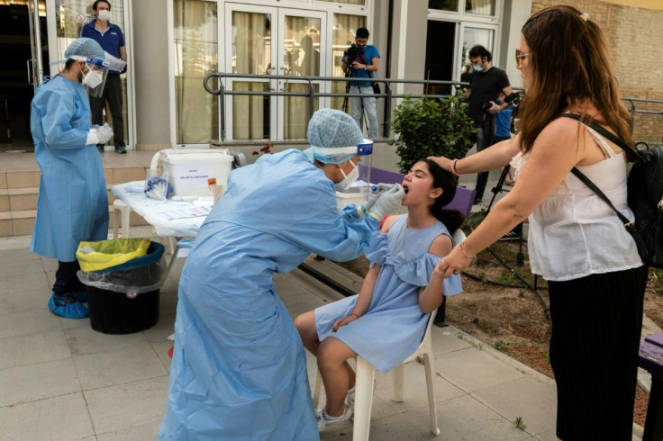 A Cypriot schoolgirl undergoes a swab test for the coronavirus on her first day back at school in the capital Nicosia after the lifting of a two-month lockdown