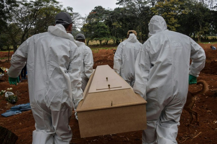 Employees carry the coffin of a person who died from COVID-19 at the Vila Formosa cemetery, in the outskirts of Sao Paulo, Brazil on May 20, 2020