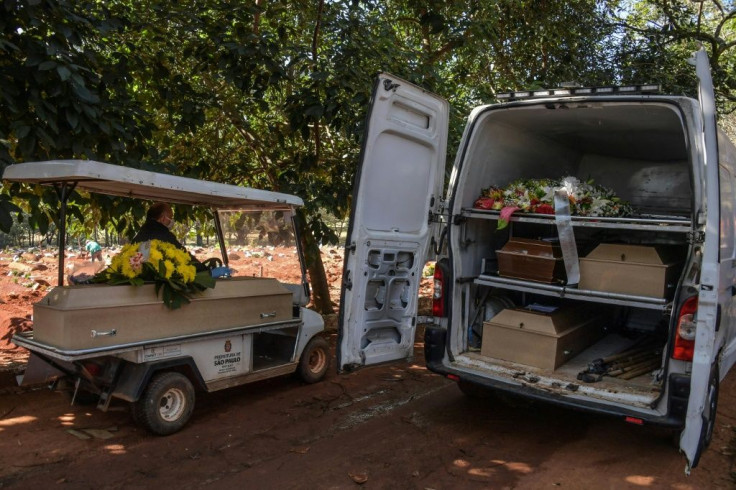 Employees carry the coffin of a person who died from COVID-19 at the Vila Formosa cemetery, in the outskirts of Sao Paulo, Brazil on May 20, 2020