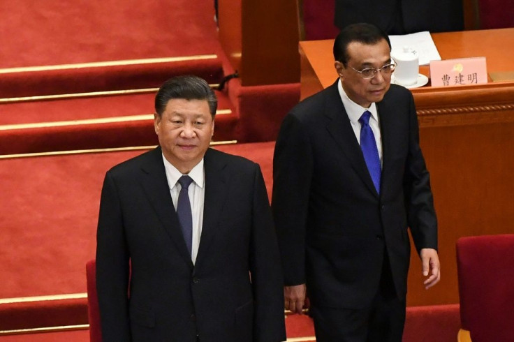 Chinese President Xi Jinping (L) and Premier Li Keqiang (R) arrive for the opening session of the Chinese People's Political Consultative Conference (CPPCC) at the Great Hall of the People in Beijing on May 21, 2020