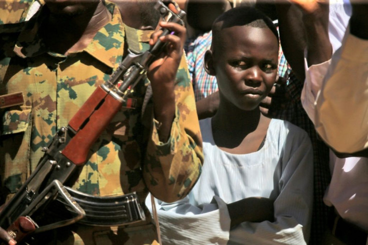 A child looks on as Sudan's Prime Minister Abdalla Hamdok visits a camp for internally displaced people in North Darfur state in November 2019