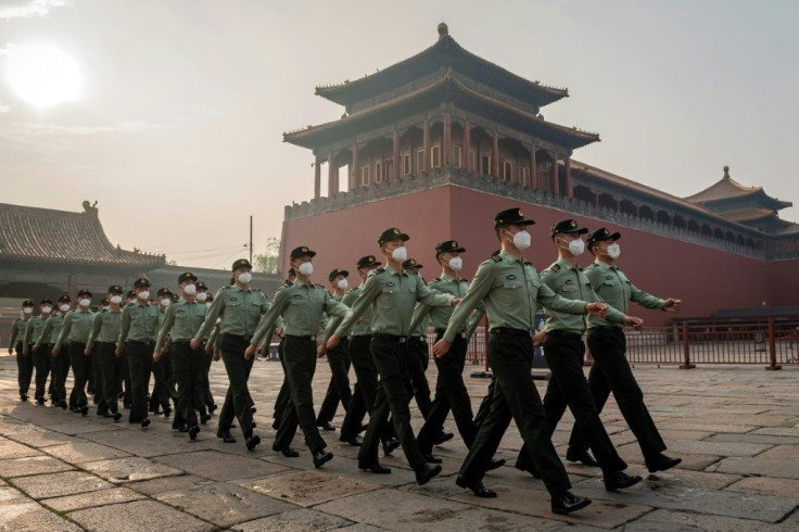 People's Liberation Army soldiers march next to the entrance to the Forbidden City during the opening ceremony of the Chinese People's Political Consultative Conference (CPPCC) in Beijing