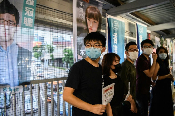 Pro-democracy Demosisto Party member Joshua Wong (C) and other members of his party distribute flyers against China's controversial national security law for Hong Kong