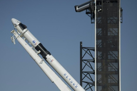 SpaceX's Falcon 9 rocket is raised into a vertical position on the launch pad ahead of the crewed mission to the International Space Station