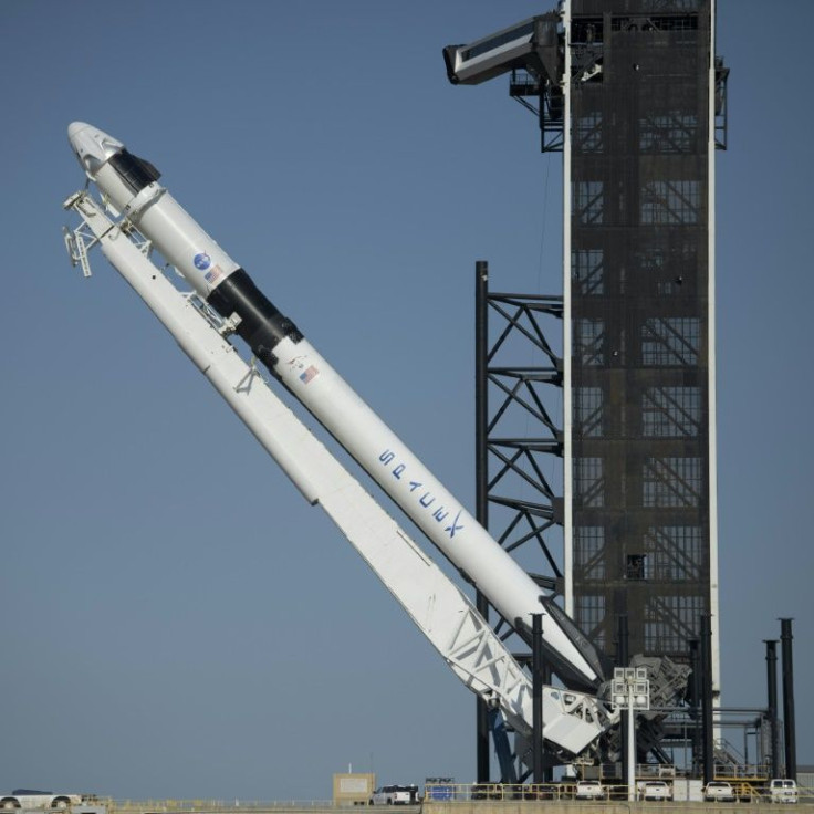 SpaceX's Falcon 9 rocket is raised into a vertical position on the launch pad ahead of the crewed mission to the International Space Station