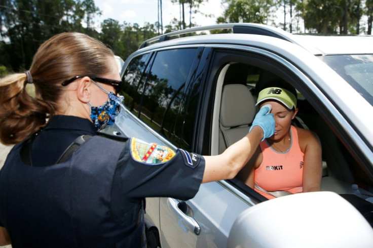 Temperature check: US tennis player Danielle Collins has her temperature taken as she arrives for the UTR Pro Match Series min-tournament in Florida