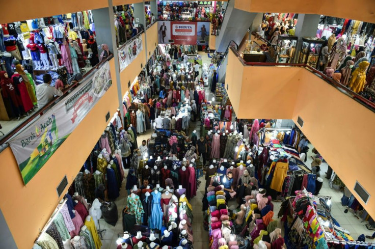 Malls and markets in Indonesia have been packed with throngs of shoppers buying food and clothes for Eid celebrations