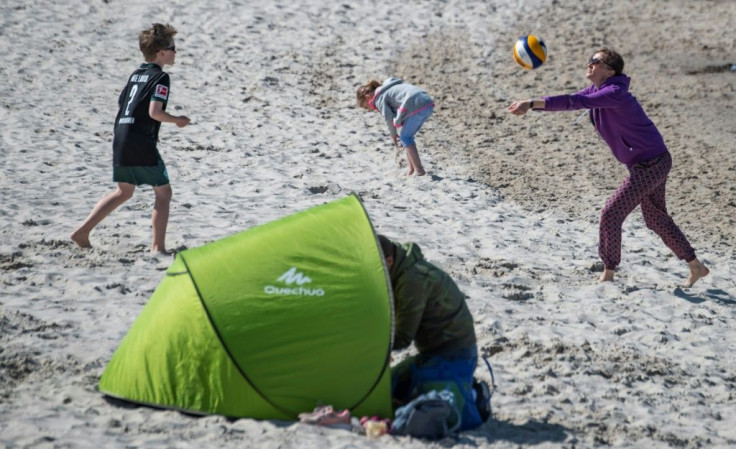 A woman plays volleyball with her son at the seaside resort of Binz, on the island of Ruegen in northeastern Germany.