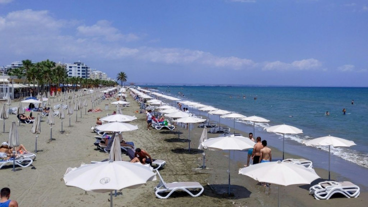 People enjoy sun and surf at Mackenzie beach in the coastal city of Larnaca on the Mediterranean island of Cyprus on May 23, 2020