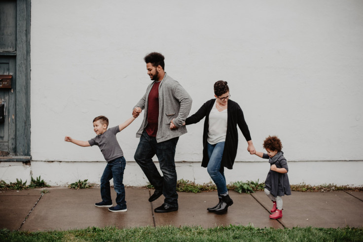 family-of-four-walking-at-the-street-2253879