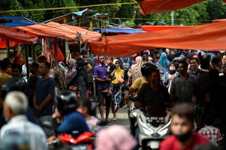 Muslims across Asia -- from Indonesia to Pakistan, Malaysia and even war-ravaged Afghanistan -- thronged markets for pre-festival shopping, flouting coronavirus guidelines