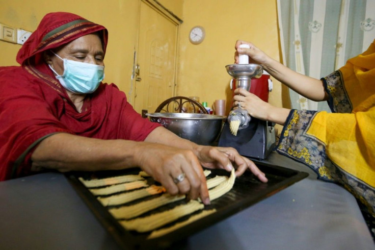 A Sudanese family prepare traditional biscuits at their home in the capital Khartoum just ahead of Eid
