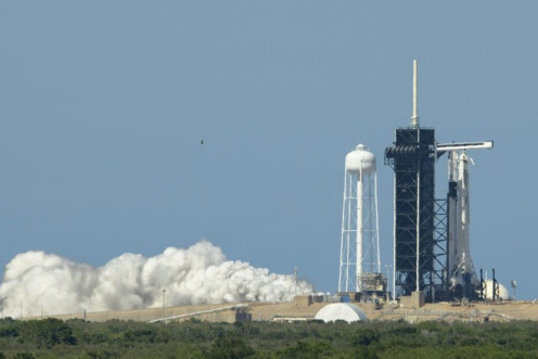 A SpaceX Falcon 9 rocket with the company's Crew Dragon spacecraft onboard at Launch Pad 39A during a brief static fire test on May 22, 2020, ahead of the first crewed flight from US soil into space since 2011