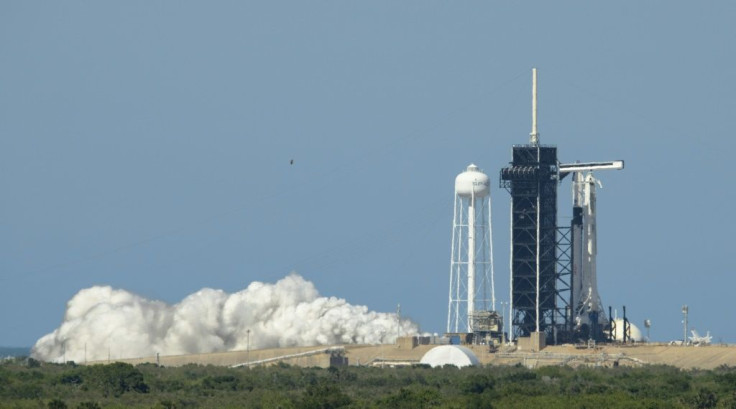 A SpaceX Falcon 9 rocket with the company's Crew Dragon spacecraft onboard at Launch Pad 39A during a brief static fire test on May 22, 2020, ahead of the first crewed flight from US soil into space since 2011