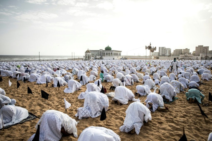 Some faithful in Senegal gathered for prayer on a nearby beach, kneeling on the sand to keep a safe distance apart