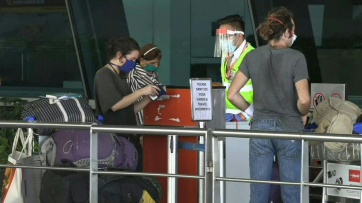 People line up at New Delhi airport as domestic flights re-commence