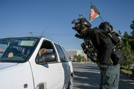 A motorist is checked by security at a checkpoint in the Afghan capital at the start of the Eid al-Fitr holiday