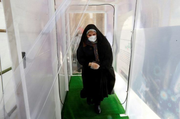 Visitors to they key Tehran shrine of Shah Abdol-Azim must walk through a disinfection tunnel and have their temperature checked