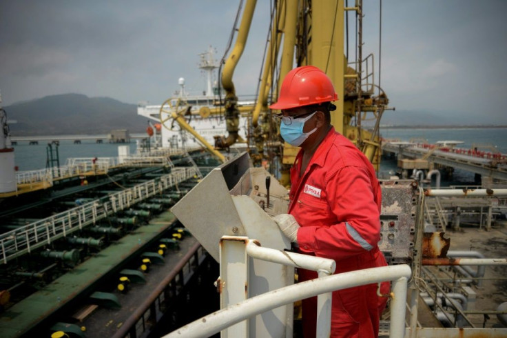 A worker of Venezuelan state oil company PDVSA watches the Iranian oil tanker Fortune dock at El Palito refinery