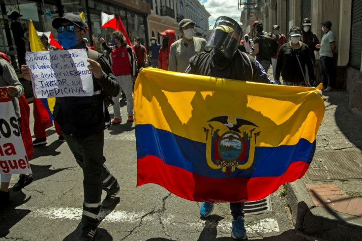 A protester holds an Ecuadorean flag during a demonstration in Quito against wage and budget cuts imposed by the government to tackle the coronavirus pandemic