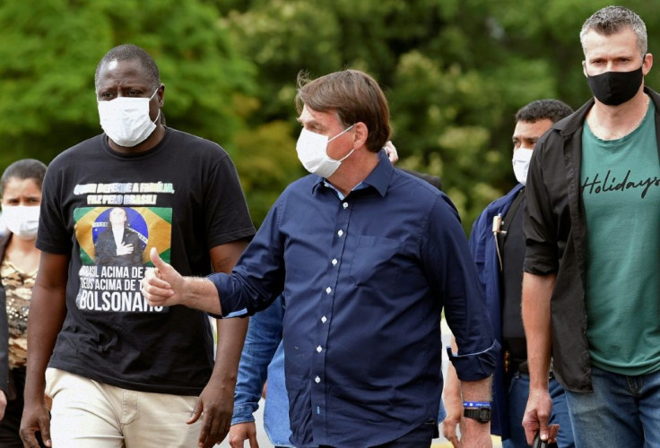 Brazilian President Jair Bolsonaro (pictured May 24, 2020), who regularly rails against the mainstream media, occasionally stops outside the Alvorada Palace in Brasilia to speak to the press, but the informal event has turned tense at times