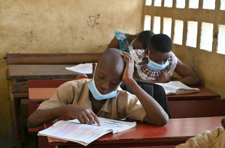 Children wear face masks at a primary school in Abidjan on the first day day after the resumption of classes after a COVID-19 lockdown