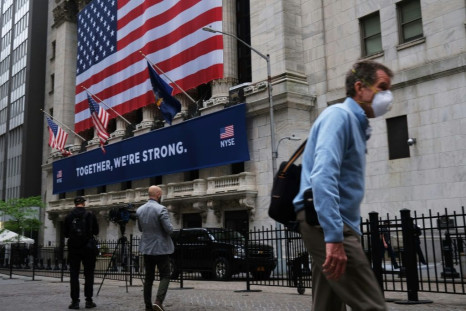 The New York Stock Exchange, the symbolic heart of Wall Street, reopened its floor after a two-month closure due to the coronavirus, with traders donning masks and separated by plexiglas