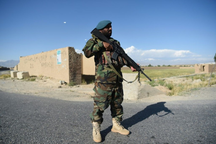 An Afghan National Army (ANA) soldier stands guard at a checkpoint in Bagram district as Taliban prisoners are released from the Bagram prison