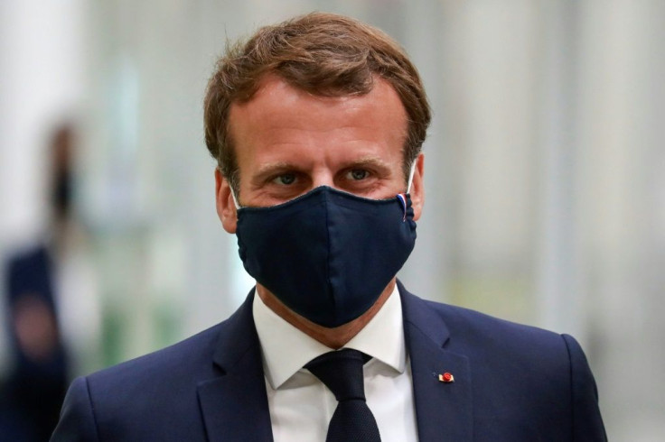 French President Emmanuel Macron, complete with mask, during his visit to a car factory in Etaples, northern France