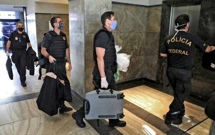 Federal police officers, pictured here carrying seized evidence, raided the residence of the governor of Rio de Janeiro, Wilson Witzel, as part of an anti-corruption investigation