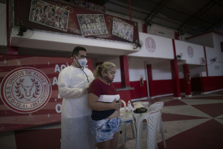 A doctor examines a woman showing symptoms of the novel coronavirus, COVID-19, during a day of free health checks at a samba school in Rio de Janeiro, Brazil, on May 24, 2020