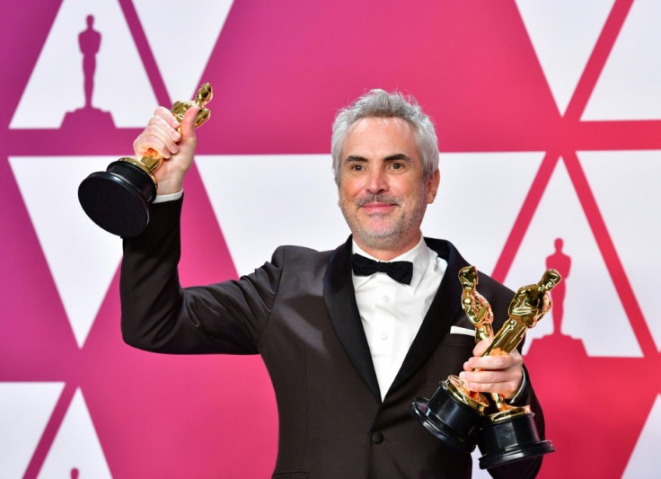 Alfonso Cuaron poses with his Oscars at the Academy Awards on February 24, 2019
