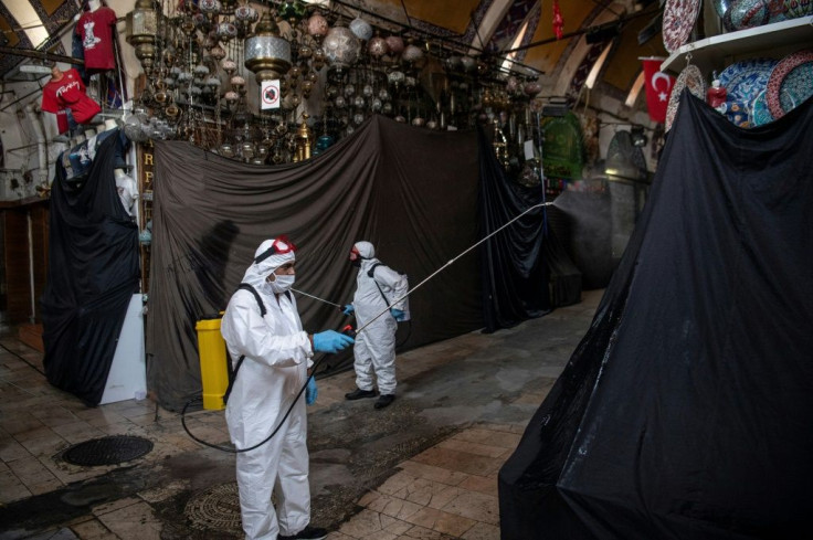 Municipal workers disinfect the market ahead of its big reopening