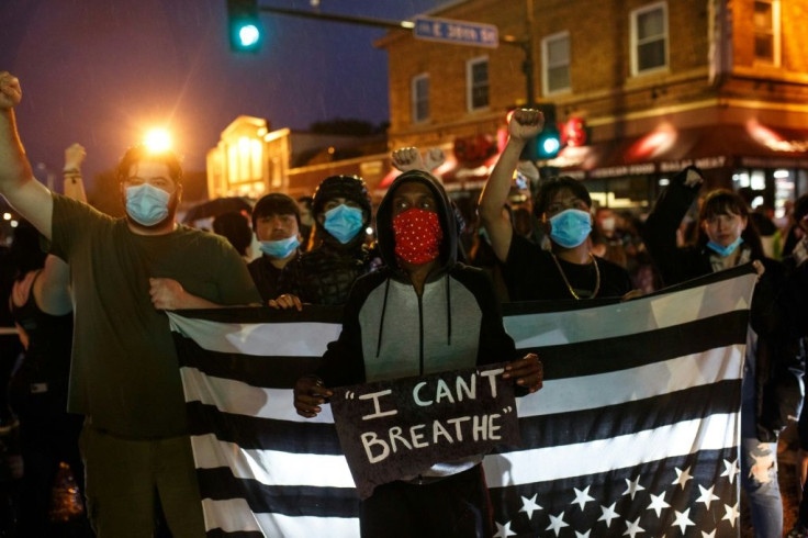 Protesters gather near the scene where George Floyd died in police custody in Minneapolis