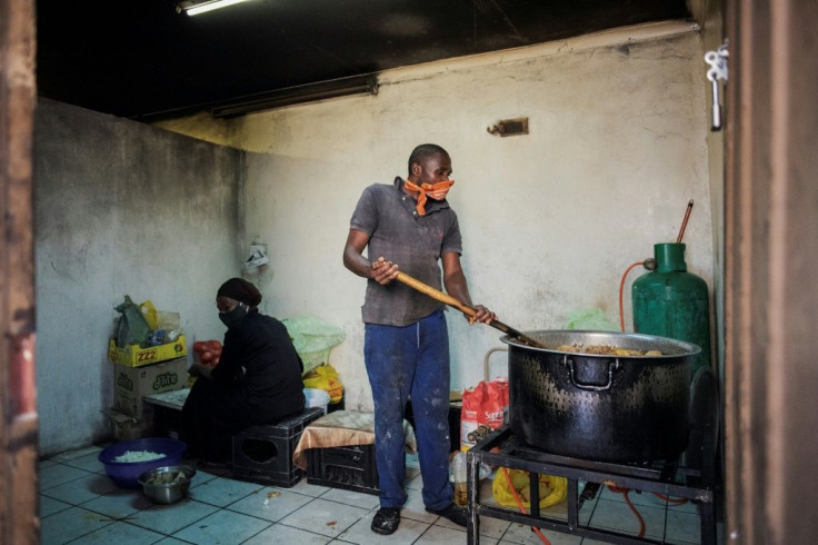 Volunteers from the African Diaspora Forum prepare hot meals for the daily food distribution in Johannesburg