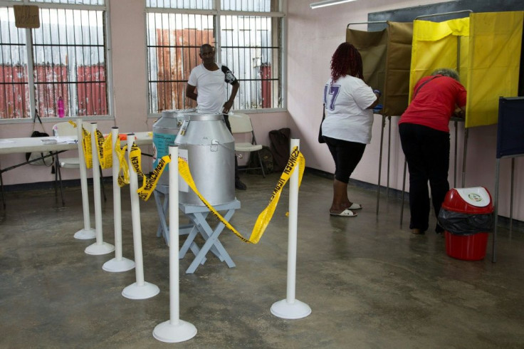 People vote at a polling station in Paramaribo on May 25, 2020