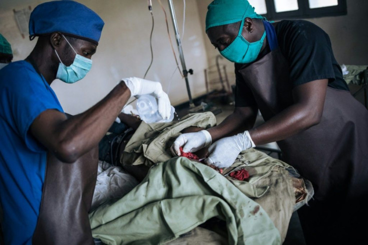 Medical staff treat a man with serious head injuries after an attack by unknown assailants in the village of Oicha in North Kivu Province, in a photo taken in January