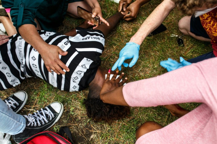 An injured protester is helped by others as demonstrators clash with police during rallies on May 27, 2020 against the death of George Floyd in Minneapolis