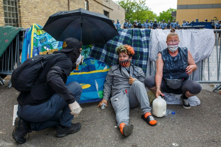 Protestors cry from from tear gas during a demonstration in Minneapolis on May 27, 2020 calling for justice for George Floyd