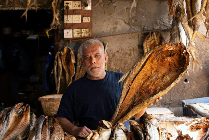 An Iraqi vendor sells dried fish in the southern Iraqi city of Basra