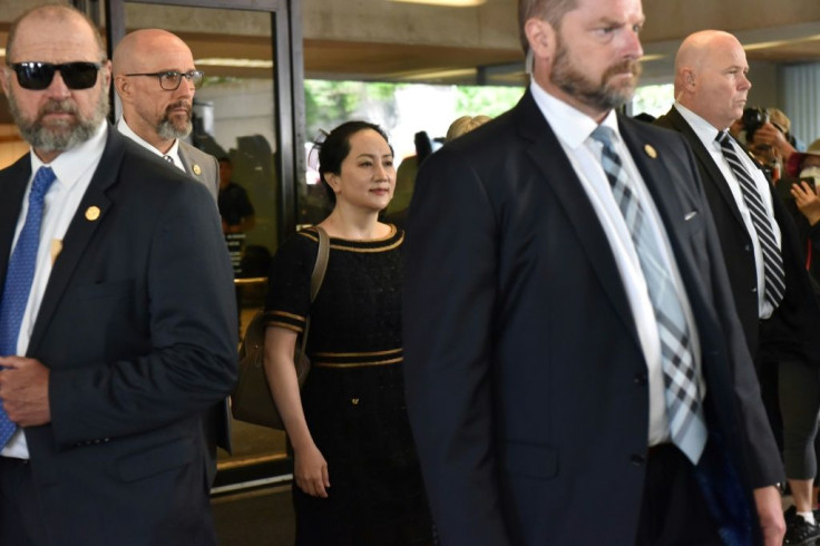 Huawei Chief Financial Officer, Meng Wanzhou (C), leaves British Columbia Supreme Court, after hearing the decision of Associate Chief Justice Heather Holmes on her double-criminality judgment in Vancouver, on May 27, 2020