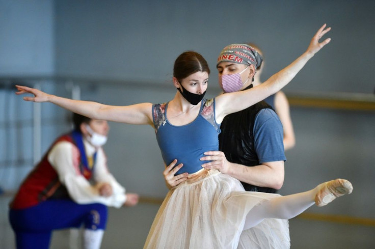 Ballet dancers wearing face masks take part in a rehearsal of Edvard Grieg's Peer Gynt ballet at the Bolshoi Theatre of Belarus in Minsk