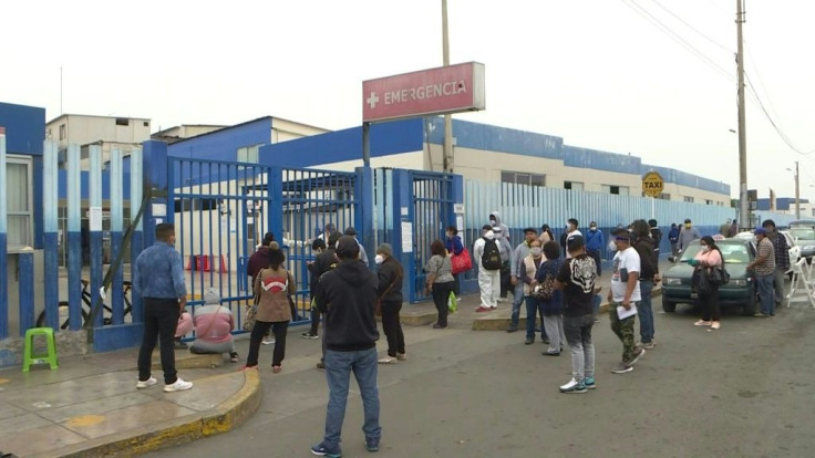 Worried relatives wait outside a Hospital in Lima, unable to enter, hoping to get some information on their loved ones infected with COVID-19.