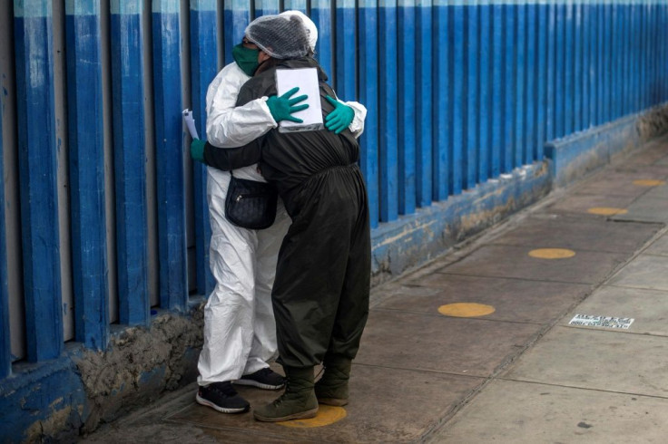 A woman mourns the death of her husband from COVID-19, outside the emergency area at Alberto Sabogal Hospital in Lima